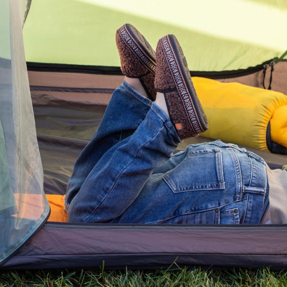 Kid's L'il Woven Trim Moccasins on figure laying outside in tent kicking feet up