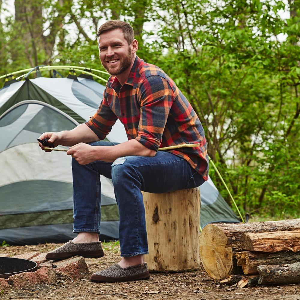 Men's Original Acorn Moccasins in Brown Tweed on Model Sitting on Stump at Campsite